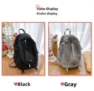 Detailed color display of minimalist nylon backpacks in both black and grey options