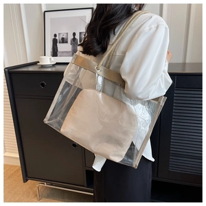 Detail view of the transparent PVC tote bag with beige canvas inner pouch and rope handles