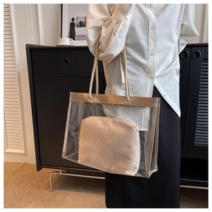 Detail of transparent PVC tote bag with beige fabric inner pouch and rope handles