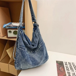 Blue washed denim hobo bag with adjustable strap and vintage pockets for women