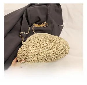 Detailed texture of cream woven crossbody bag featuring a classic gold metal chain strap