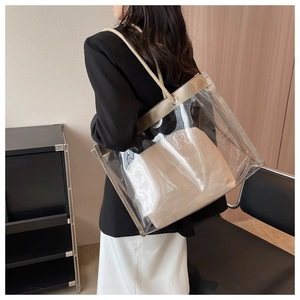 Detail of transparent PVC tote bag with a beige inner pouch and braided rope handles
