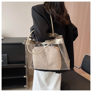 Back view of model wearing a transparent PVC tote bag with rope handles and inner pouch