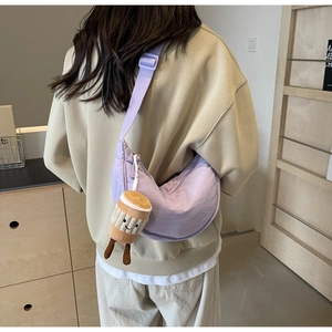 Purple crescent crossbody bag with cute coffee cup plush charm on adjustable strap
