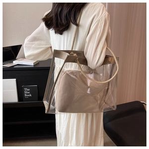 Transparent PVC shoulder bag with beige woven rope handles and a khaki fabric inner pouch