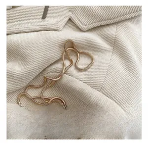 Macro view of a premium polished gold snake chain strap on beige corduroy fabric