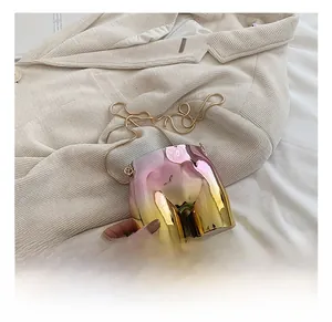 Detail of artistic torso shaped crossbody bag with pink-gold gradient metallic finish