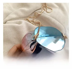 Detail of metallic gradient crossbody bag with golden snake chain and secure lobster clasp
