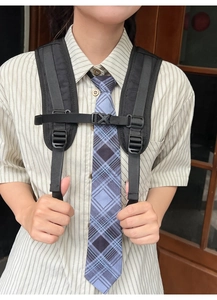 Detail of adjustable nylon chest strap with buckle on backpack shoulder straps