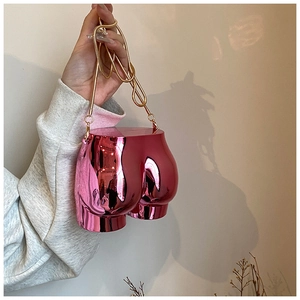 Detail of pink mirror finish mini bag with gold chain strap in unique body shape