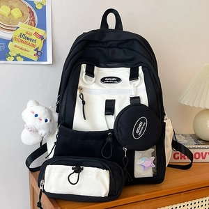 Minimalist nylon backpack for women with black and white contrast and multiple accessory pouches
