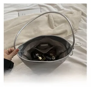 Internal view of silver PU bucket bag showing large capacity for cosmetics and perfume
