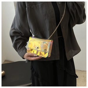 Detail of holographic crossbody bag with gold chain strap and metallic finish