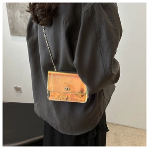 Detail view of colorful laser gradient crossbody bag with gold chain and round twist lock