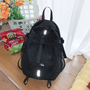 Minimalist black nylon backpack with reflective safety strips and side mesh pockets
