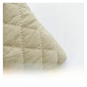 Close-up detail showing premium quilted khaki fabric with refined diamond stitch texture