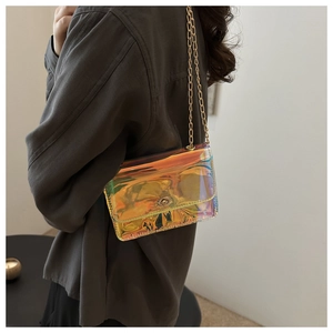 Detailed view of iridescent laser crossbody bag with golden chain and circular metal lock
