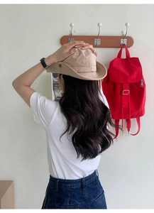 Khaki nylon bucket hat shown from a back view on a model with outdoor casual styling