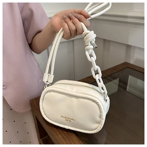 Detail of white PU leather crossbody bag featuring gold logo and unique chain handle