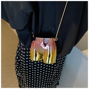 Detailed view of creative torso-shaped crossbody bag with metallic gradient finish and chain