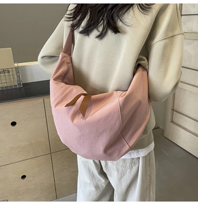 Detailed back view of pink canvas hobo crossbody bag with stylish brown zipper pull