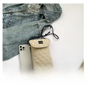Detailed view of quilted fabric phone bag showing internal capacity with a smartphone