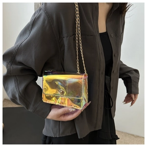 Detail view of mini iridescent laser PVC crossbody bag with golden chain and metal lock
