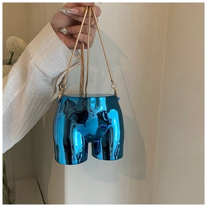 Close-up of bright blue metallic mirror finish bag with gold snake chain strap
