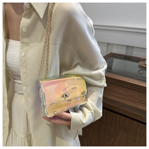 Close-up of holographic crossbody bag with gold chain strap and metal swivel lock