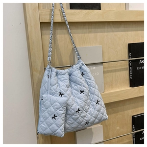 Light blue quilted chain shoulder bag with embroidered bows and small hanging pouch