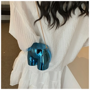 Detail of surrealist blue mirror torso bag with fine gold chain strap and metallic finish