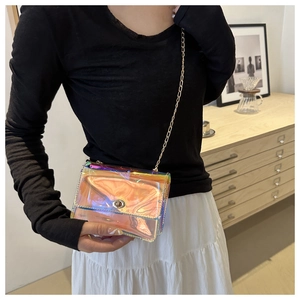 Detail of laser holographic mini crossbody bag with silver chain strap and metal swivel lock