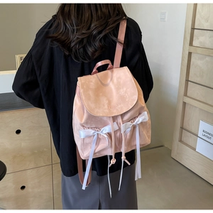 Pink fabric backpack featuring elegant white satin side bows and embroidered Nika logo