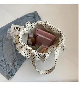 Interior view of large capacity dalmatian print tote bag showing daily items inside