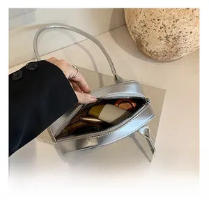 Spacious interior of a stylish silver PU leather handbag showing phone and makeup storage