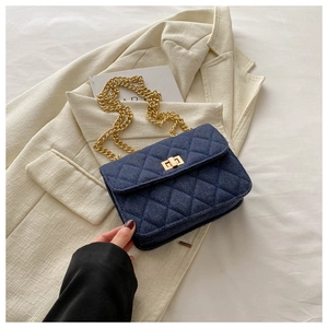 Classic navy denim crossbody bag with gold chain strap and elegant quilted pattern