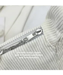 Detail of corduroy crossbody bag with smooth metal zipper and decorative bead chain