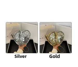Detail of silver and gold heart-shaped bags with large round sparkling sequins and chain strap