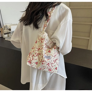 Beige floral canvas bag with lace ruffles and Fashion Instinct label on shoulder