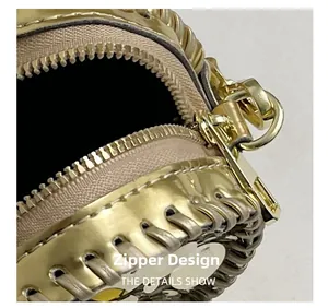 Detail of the high-quality golden metal zipper and woven trim on the heart-shaped bag