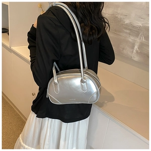 Close-up of a silver metallic bowling bag shown on shoulder in a lifestyle setting