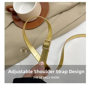 Close-up of adjustable golden metallic strap with polished buckle on a trendy crossbody bag