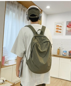 Army green nylon backpack for urban commute showing large capacity for laptops