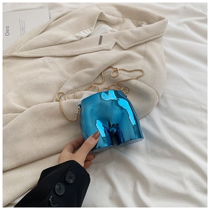 Artistic bright blue metallic crossbody bag in a unique human-form creative design