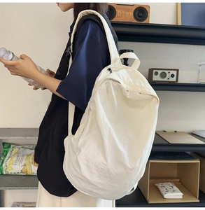 Detail of white large nylon backpack with pleated texture for daily commute