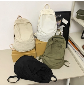 Minimalist waterproof nylon backpacks in four colors with smooth zippers and top handles