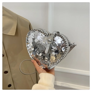 Silver sequin heart-shaped crossbody bag with adjustable metallic strap for women