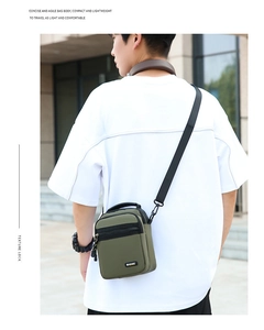 Detail of lightweight army green nylon crossbody bag showing multiple zip pockets and strap