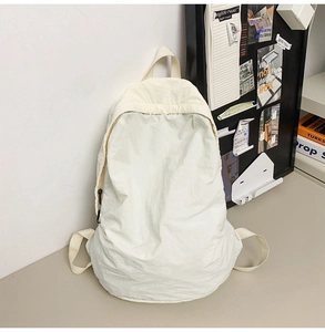 Detail of white nylon backpack with crinkled texture fabric and top handle for women