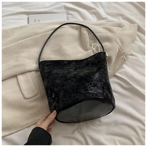 Minimalist black textured PU leather bucket bag with pearl strap for stylish women